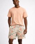 Man wearing a peach t-shirt and RF-Wear Men's Mesh Carnation Shorts in Cream/Peach