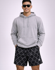 Man wearing a grey hoodie and RF-Wear Men's Mesh Chain Link Shorts in Black/Grey