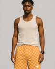 Man Wearing tank top and RF-Wear Men's Mesh Checkered Shorts in Peach