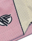 Close-up of RF-Wear Men's Mesh Cream Stripe V-Cut Shorts in Pink with RF logo