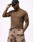 Man wearing brown t-shirt and RF-Wear Men's Mesh Desert Camo Shorts in Tan/Brown