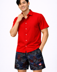 Man wearing a red shirt and RF-Wear Men's Mesh Fireworks Shorts in Black/Red/White/Blue