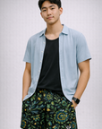 Man wearing a shirt and RF-Wear Men's Mesh Floral Shorts in Black/Blue/Green/Yellow