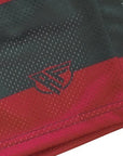Close-up of RF-Wear Men's Mesh Freddy Shorts in Red/Green with RF logo