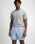 Man wearing a grey t-shirt and RF-Wear Men's Mesh Grey Checkered Trim shorts in powder blue