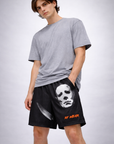 Man wearing a grey top and RF-Wear Men's Mesh Horror One Face Boogeyman Shorts in Black