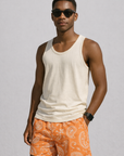 Man wearing a white tank top and RF-Wear Men's Mesh Paisley Shorts in Apricot/Cream