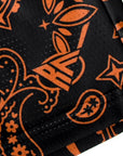 Close-up of RF-Wear Men's Mesh Paisley Shorts in Black/Orange with RF logo