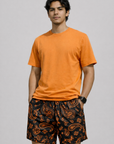 Man wearing a orange t-shirt and RF-Wear Men's Mesh Paisley Shorts in Black/Orange