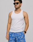 Man wearing a white tank top and RF-Wear Men's Mesh Paisley Shorts in Blue/White