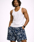 Man wearing a white tank top and RF-Wear Men's Mesh Paisley Shorts in Navy/Cream