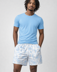 Man wearing a blue t-shirt and RF-Wear Men's Mesh Paisley Shorts in White/Sky Blue