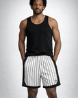 Man wearing a black tank top and RF-Wear Men's Mesh Pinstripe Basketball Shorts in White/Black