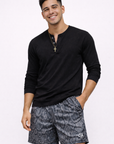 Man wearing a black top and RF-Wear Men's Mesh Snakeskin Shorts in Black