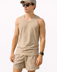 Man wearing a tan tank top, cap, and RF-Wear Men's Mesh Snakeskin Shorts in Cream/Tan