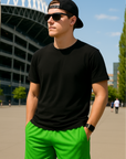 Man wear a black t-shirt and RF-Wear Men's Mesh Solid Color Shorts in Lime Green