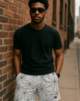 Man wearing a black t-shirt and RF-Wear Men's Mesh Spider Web Shorts in White