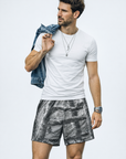 Man wearing a t-shirt and RF-Wear Men's Mesh Tree Camo Shorts in Grey