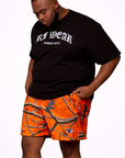 Man wearing a black shirt and RF-Wear Men's Mesh Tree Camo Shorts in Orange