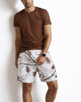 Man wearing a brown t-shirt and RF-Wear Men's Mesh Tree Camo Shorts in Snow