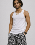 Man wearing a white tank top and RF-Wear Men's Paisley 2.0 Shorts in Black/White