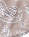 Close-up of RF-Wear Men's Paisley Shorts in Tan/White with RF logo