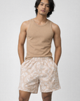 Man wearing a tan tank top and RF-Wear Men's Paisley Shorts in Tan/White