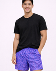 Man wearing a black t-shirt and RF-Wear Men's Snakeskin Shorts in Purple