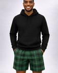 Man wearing a black hoodie and RF-Wear Men's Tartan Plaid Shorts in Green
