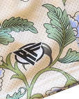 Decorative fabric with carnation patterns and a logo in the center