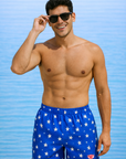 Man wearing RF-Wear Men's Swim Trunks in Blue with White Stars