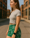 Woman standing in city wearing RF-Wear Women's Paisley Shorts - Green/White - Side View