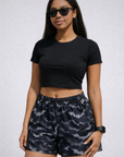 Woman wearing a black crop top and RF-Wear Women's Bats Shorts in Black/Grey
