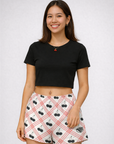 Woman wearing a black crop top and RF-Wear Women's Black Cherry Shorts in Red/White