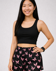 Woman wearing a black top and RF-Wear Women's Butterfly Shorts in Black/Pink