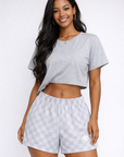 Woman wear a grey top and RF-Wear Women's Checkered Shorts in Grey