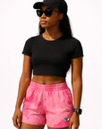 Woman wearing with black top and RF-Wear Women's Desert Camo Shorts in Pink