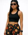 Woman Wearing a black top, cap, andRF-Wear Women's Floral Shorts in Black/Red/Peach