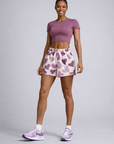 Woman wearing a purple top and RF-Wear Women's Heart Shorts in White/Purple