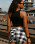 Woman at race track wearing a black crop top and RF-Wear Women's Houndstooth Shorts - Black/White - Back View