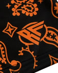 Close-up of RF-Wear women's paisley shorts in Black/Orange with RF logo