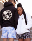 Woman standing near a friend wearing white hoodie and RF-Wear Women's Paisley Shorts in Black/White - Front View