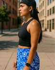 Woman standing on the city street wearing RF-Wear Women's Paisley Shorts - Blue/White - Side View