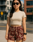 Woman standing in City wearing RF Wear Women's Paisley Shorts - Merlot/Cream - Front View