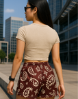 Woman standing in City wearing RF Wear Women's Paisley Shorts - Merlot/Cream - Back View