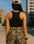 Woman standing on city sidewalk wearing RF-Wear Women's Paisley Shorts - Mocha/Cream - Back View