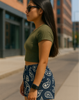 Woman on city sidewalk wearing RF-Wear Women's Paisley Shorts - Navy/Cream - Back View