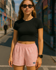 Woman standing on city street wearing RF-Wear Women's Paisley Shorts - Pink/Cream - Front View
