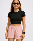 Woman wearing a black top and RF-Wear Women's Paisley Shorts in Pink/Cream