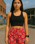 Woman standing on street with buildings in background wearing RF-Wear Women's Paisley Shorts - Red/White - Front View